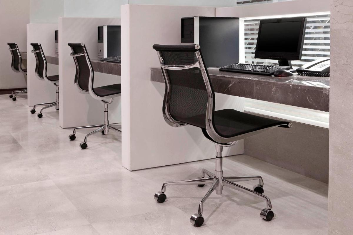 an office with three chairs and a desk with a computer at The Westin Hyderabad Mindspace in Hyderabad