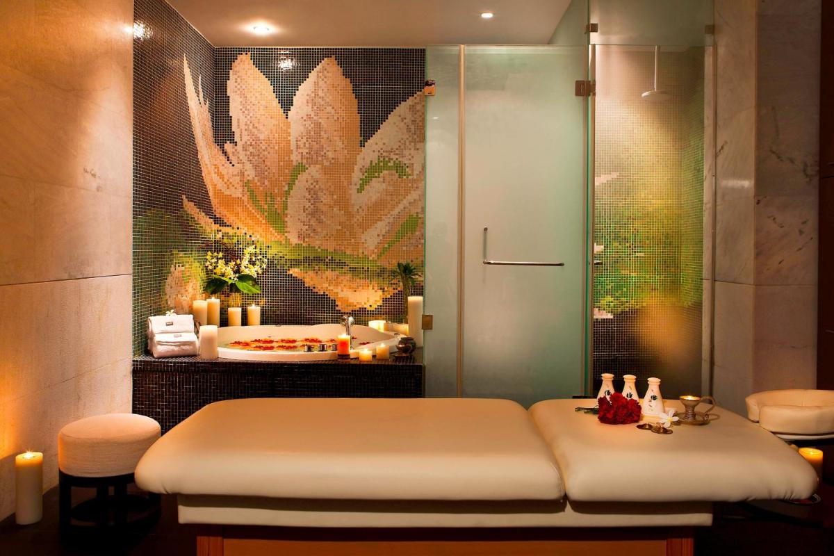 a bathroom with a massage table and a sink at The Westin Hyderabad Mindspace in Hyderabad