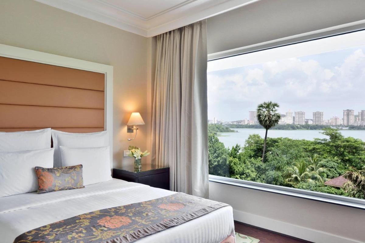 a bedroom with a bed and a large window at Marriott Executive Apartment - Lakeside Chalet, Mumbai in Mumbai a bedroom with a bed and a large window at Marriott Executive Apartment - Lakeside Chalet, Mumbai in Mumbai