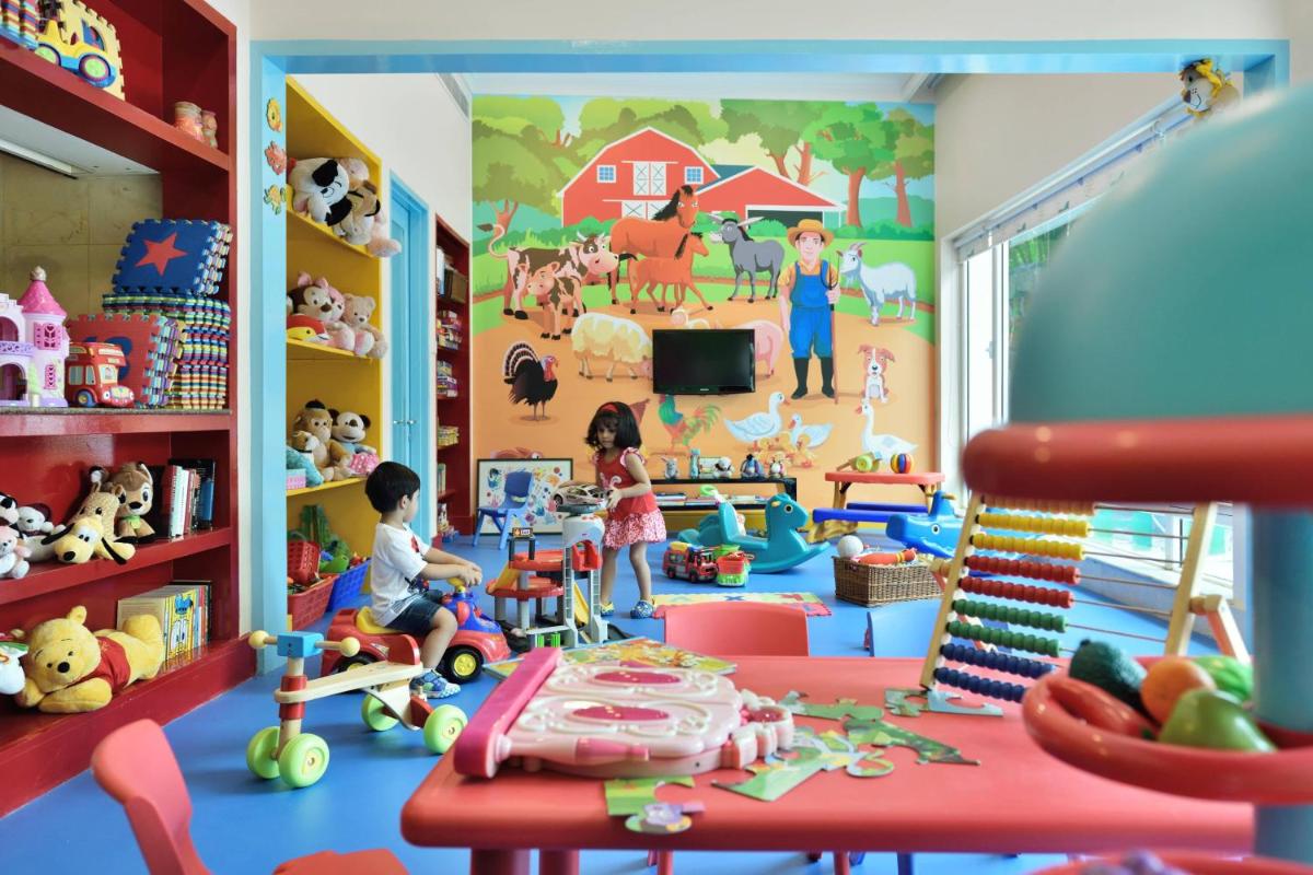 a play room with toys and a wall with a mural at Marriott Executive Apartment - Lakeside Chalet, Mumbai in Mumbai