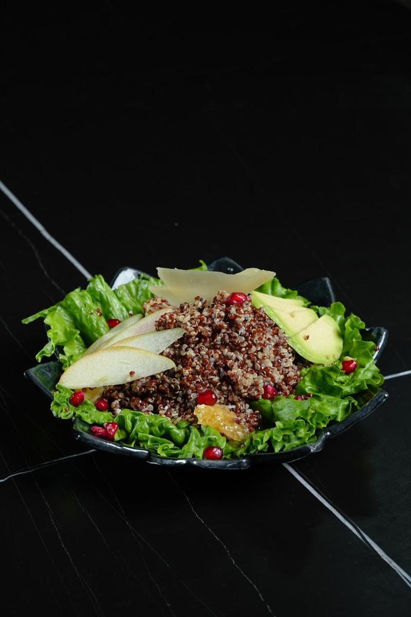 a salad on a plate on a black table at Hyatt Place Haridwar in Haridwār