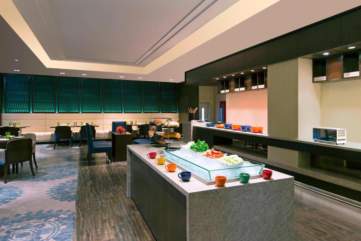 a hotel lobby with a buffet in the middle at Sheraton Hyderabad Hotel in Hyderabad