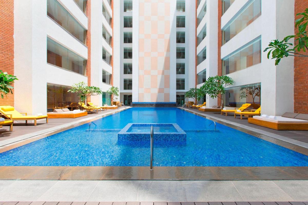 a swimming pool in the middle of a building at Sheraton Hyderabad Hotel in Hyderabad