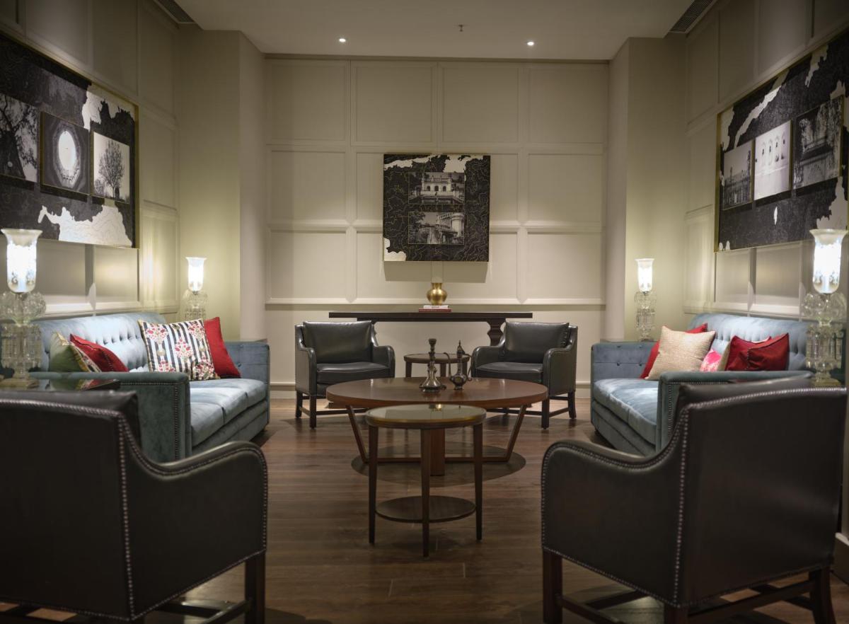 a living room with couches and a table at The Leela Hyderabad Banjara Hills in Hyderabad