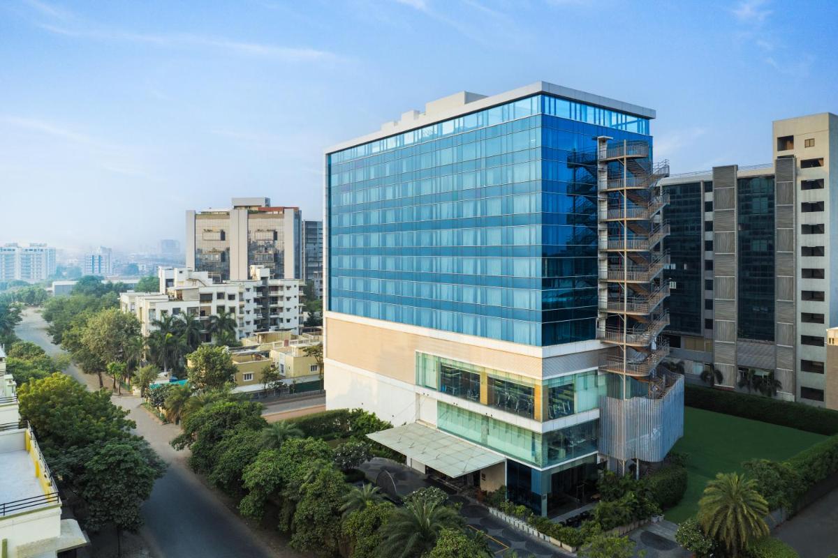an overhead view of a tall glass building in a city at Renaissance Ahmedabad Hotel in Ahmedabad