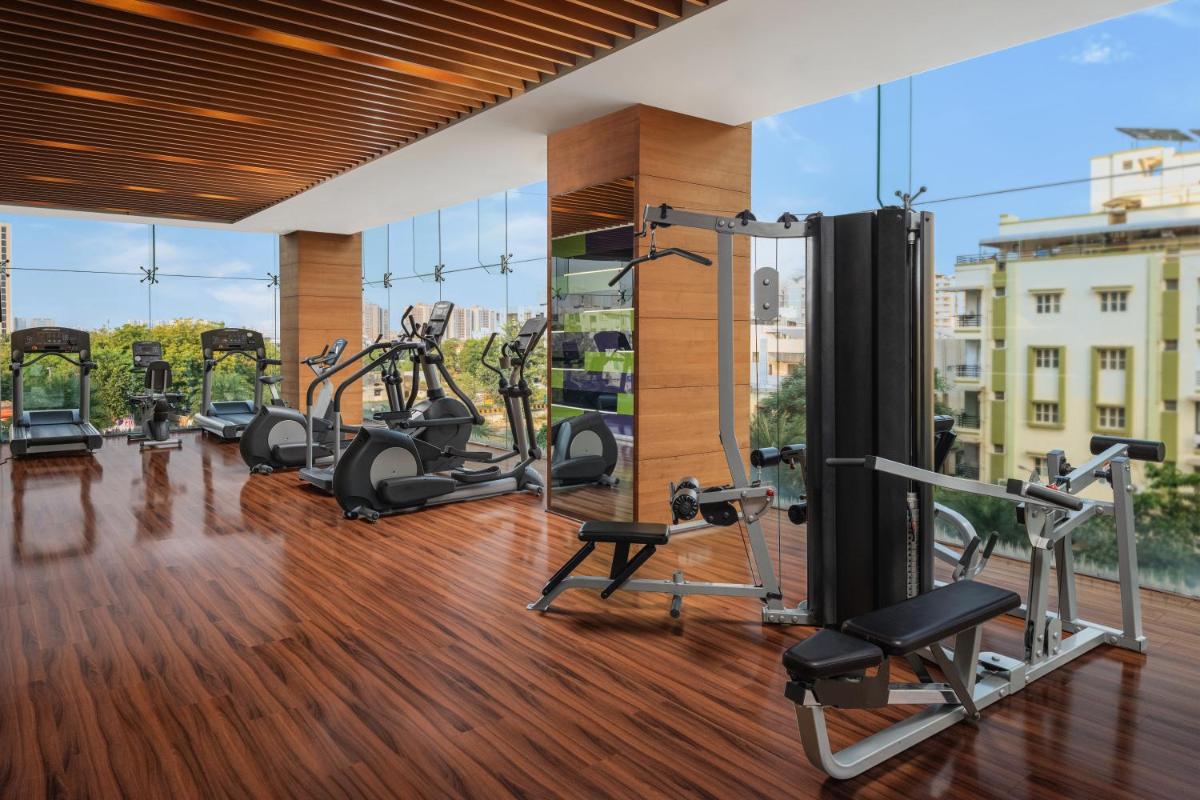 a gym with treadmills and cardio equipment in a building at Renaissance Ahmedabad Hotel in Ahmedabad