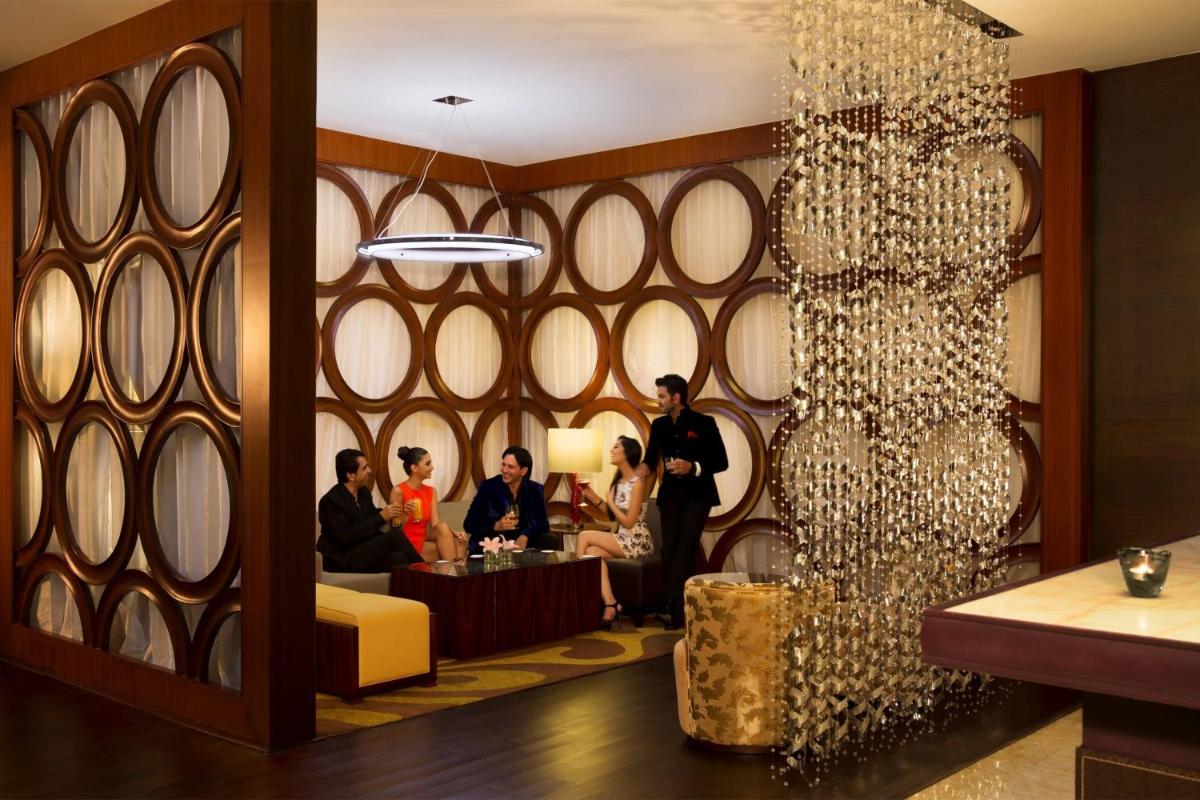 a group of people sitting at a table in a room at JW Marriott Hotel Bengaluru in Bengaluru