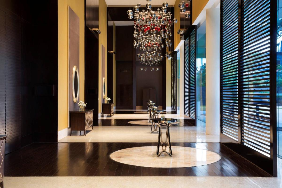 a dining room with tables and a chandelier at JW Marriott Hotel Bengaluru in Bengaluru