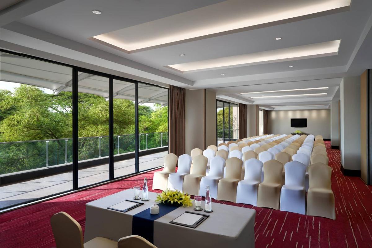 a boardroom with a large room with a conference table and chairs at JW Marriott Hotel Bengaluru in Bengaluru +38 photos