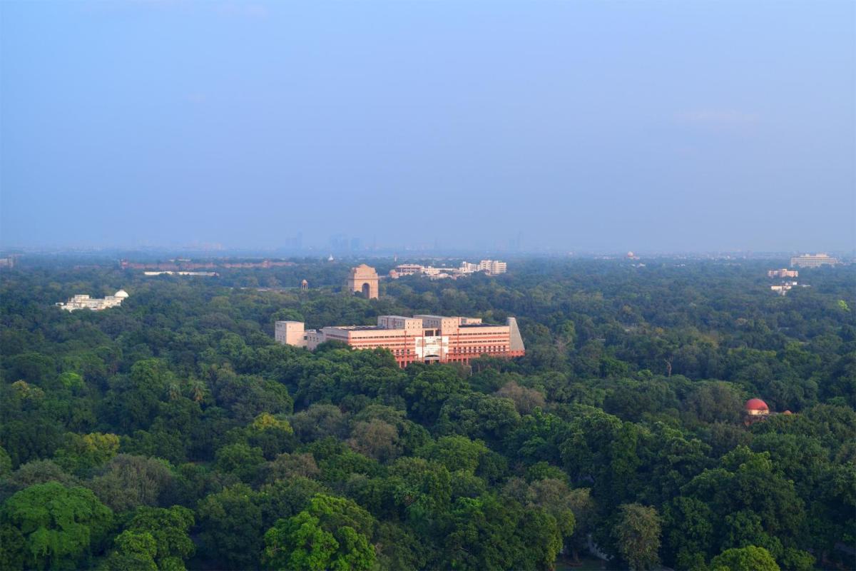 an aerial view of a building in the middle of a forest at Le Meridien New Delhi in New Delhi an aerial view of a building in the middle of a forest at Le Meridien New Delhi in New Delhi
