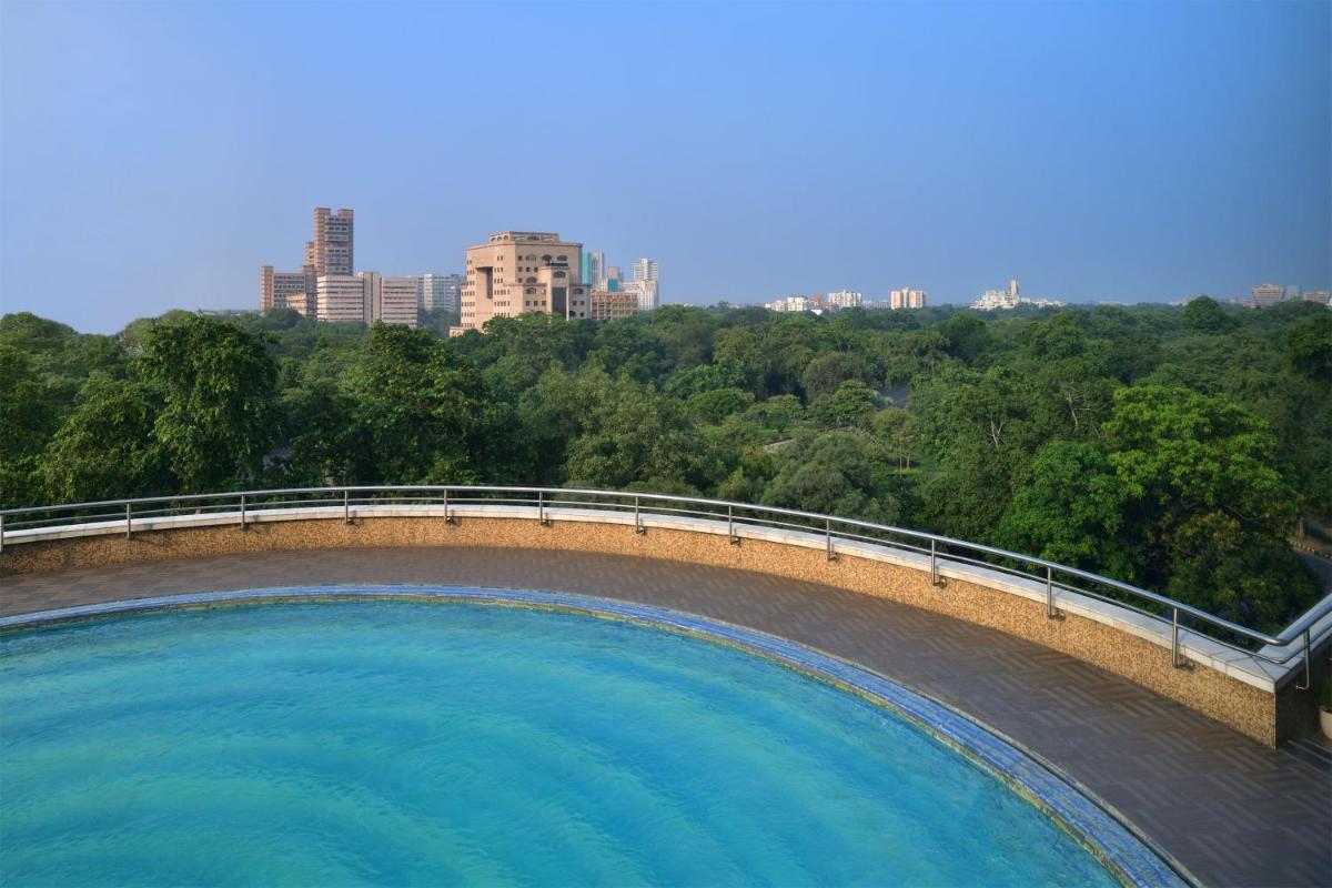 a large pool of water with a city in the background at Le Meridien New Delhi in New Delhi a large pool of water with a city in the background at Le Meridien New Delhi in New Delhi
