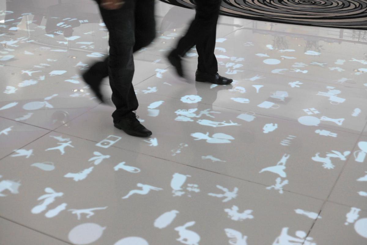 two people walking on a floor with footprints on it at Le Meridien New Delhi in New Delhi two people walking on a floor with footprints on it at Le Meridien New Delhi in New Delhi
