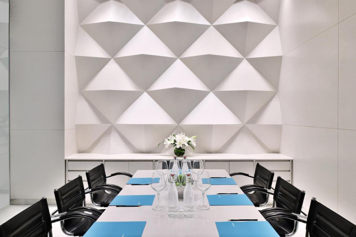 a conference room with a table and chairs at Le Meridien New Delhi in New Delhi a conference room with a table and chairs at Le Meridien New Delhi in New Delhi