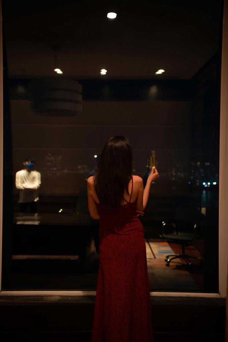 a woman in a red dress holding a glass of wine at The Westin Mumbai Powai Lake in Mumbai