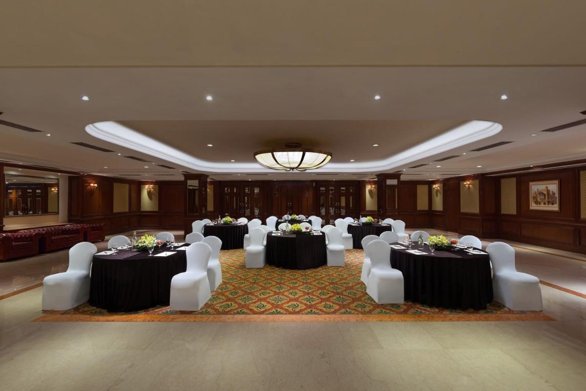 a banquet hall with tables and chairs and a chandelier at Sheraton New Delhi Hotel in New Delhi a banquet hall with tables and chairs and a chandelier at Sheraton New Delhi Hotel in New Delhi