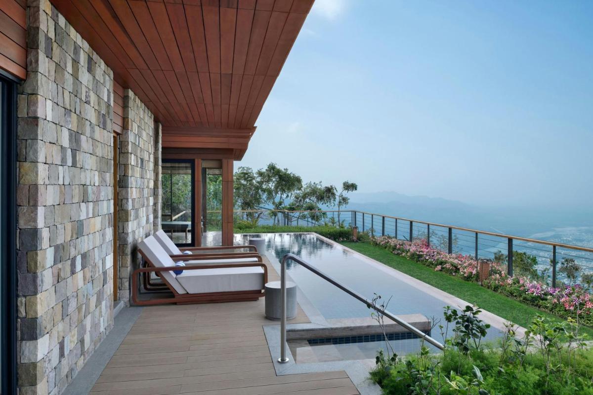 a balcony of a house with a swimming pool at The Westin Resort & Spa Himalayas in Rishīkesh