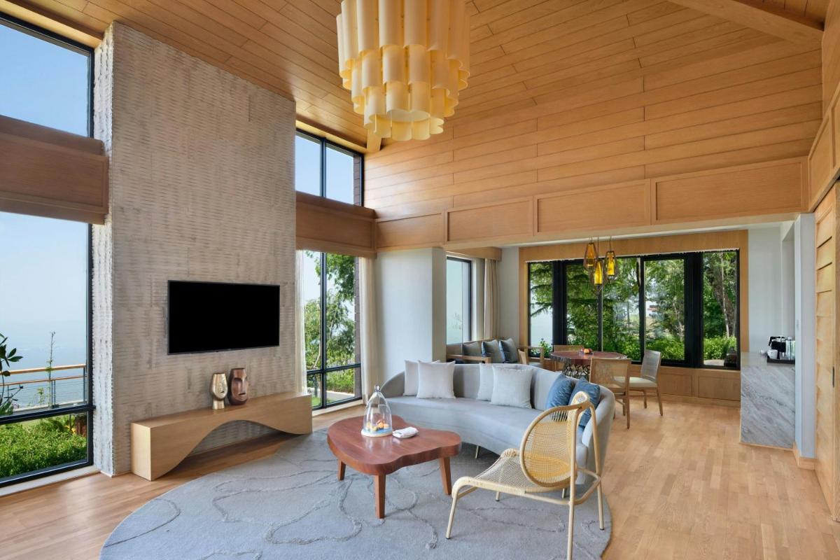 a living room with a couch and a tv at The Westin Resort & Spa Himalayas in Rishīkesh