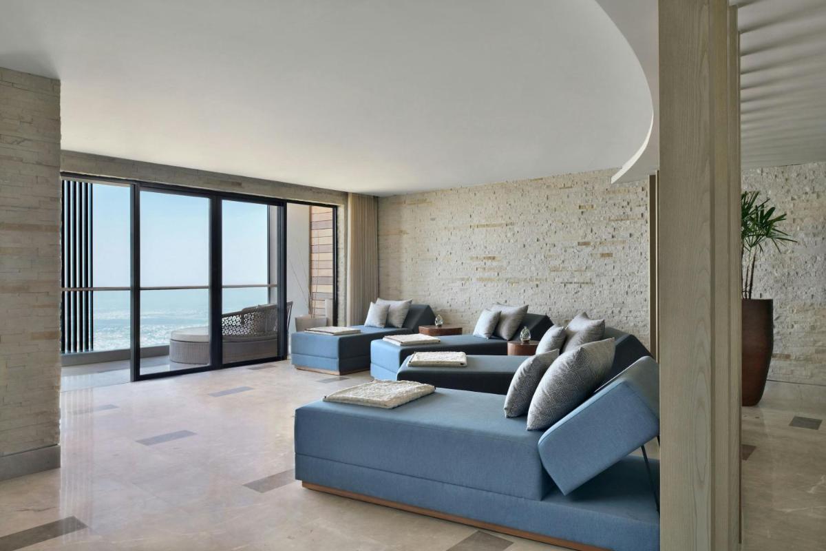 a living room with two blue couches at The Westin Resort & Spa Himalayas in Rishīkesh