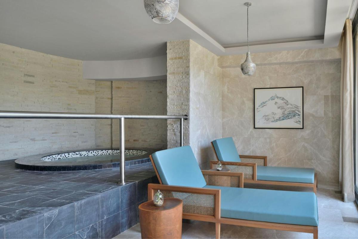 a lobby with two chairs and a bed at The Westin Resort & Spa Himalayas in Rishīkesh