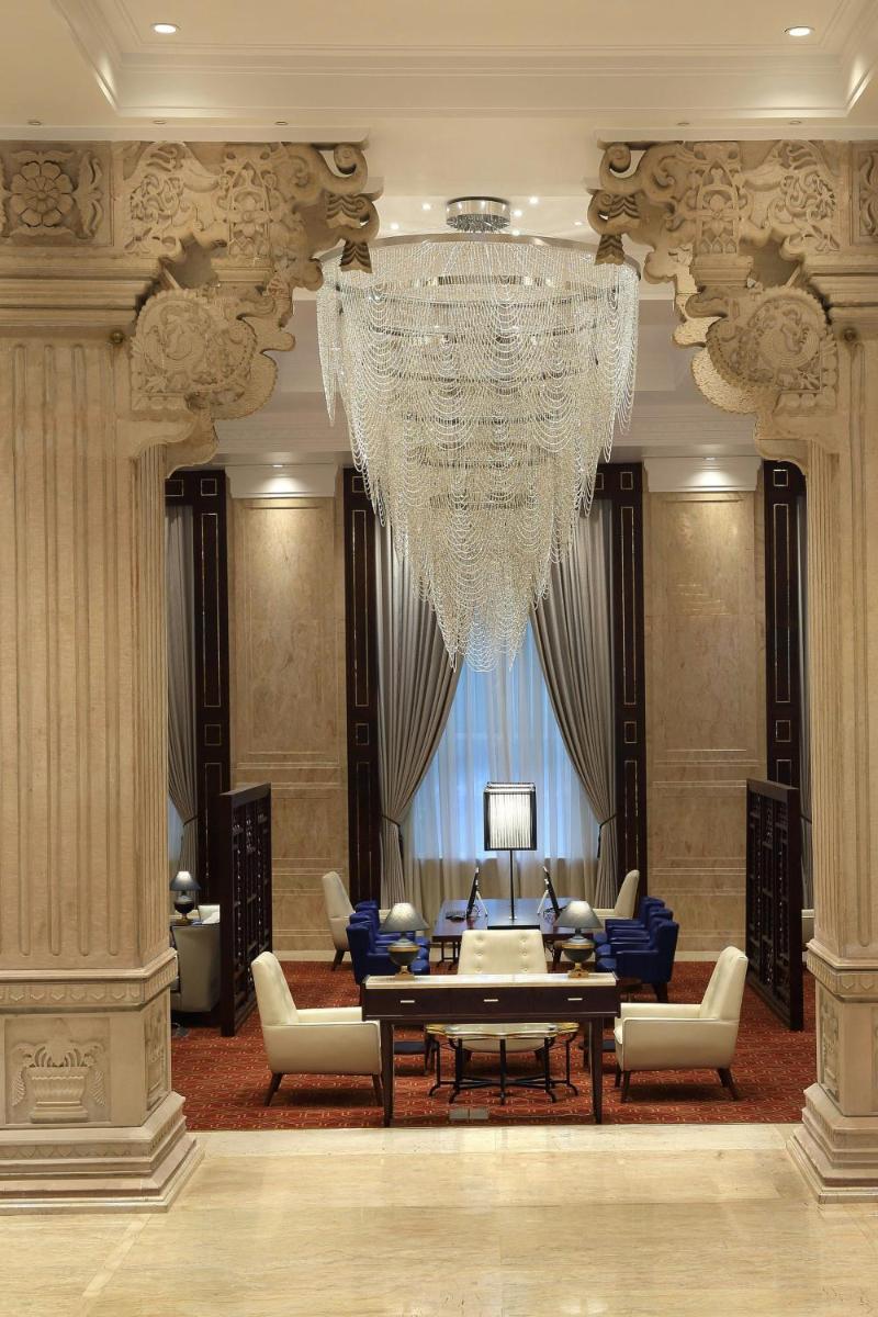 a large living room with a chandelier in a building at Sheraton Grand Pune Bund Garden Hotel in Pune