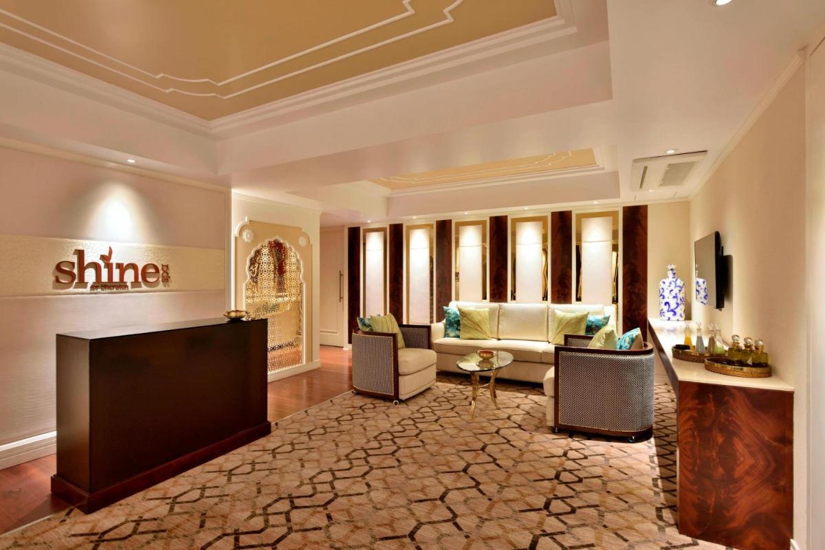a living room with a couch and a table at Sheraton Grand Pune Bund Garden Hotel in Pune a living room with a couch and a table at Sheraton Grand Pune Bund Garden Hotel in Pune