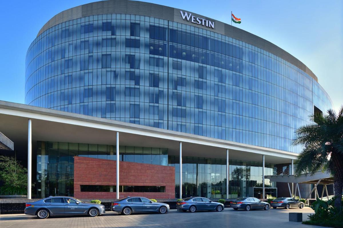 a building with cars parked in front of it at The Westin Gurgaon, New Delhi in Gurgaon