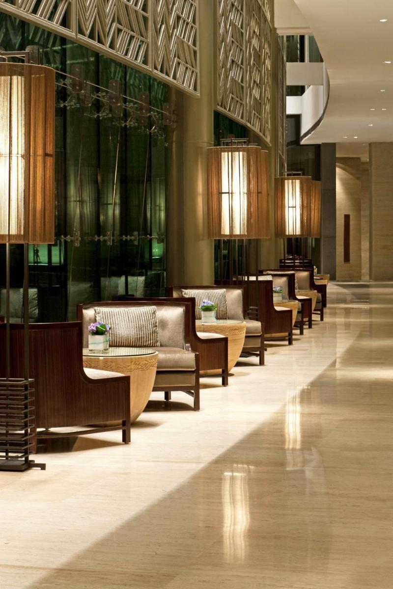 a lobby with couches and tables in a building at The Westin Gurgaon, New Delhi in Gurgaon