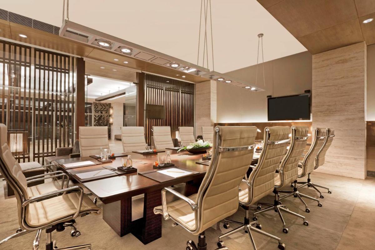 a conference room with a long table and chairs at The Westin Gurgaon, New Delhi in Gurgaon