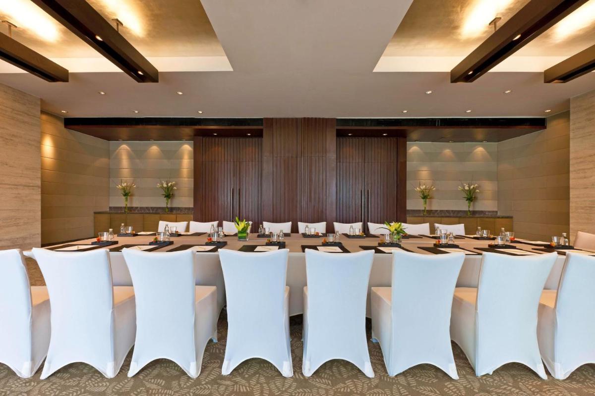 a large conference room with a long table and chairs at The Westin Gurgaon, New Delhi in Gurgaon