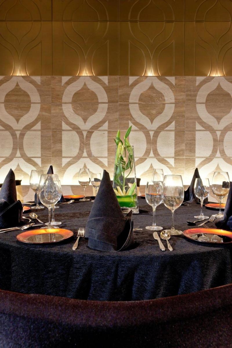 a table with wine glasses and napkins on it at The Westin Gurgaon, New Delhi in Gurgaon