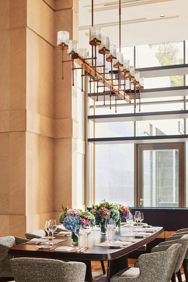 a dining room with a long table with chairs at The Ritz-Carlton, Pune in Pune