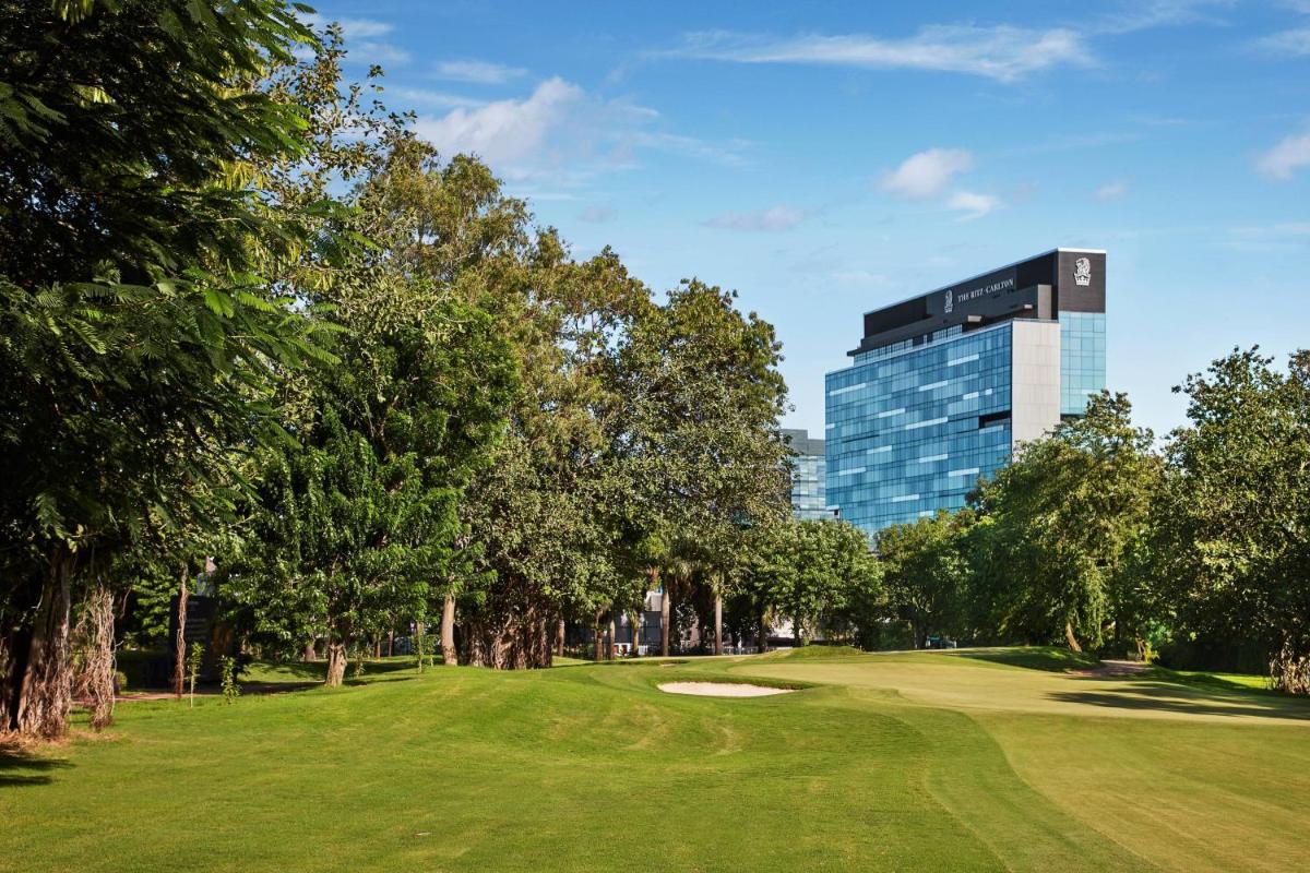 a golf course with a green in front of a building at The Ritz-Carlton, Pune in Pune