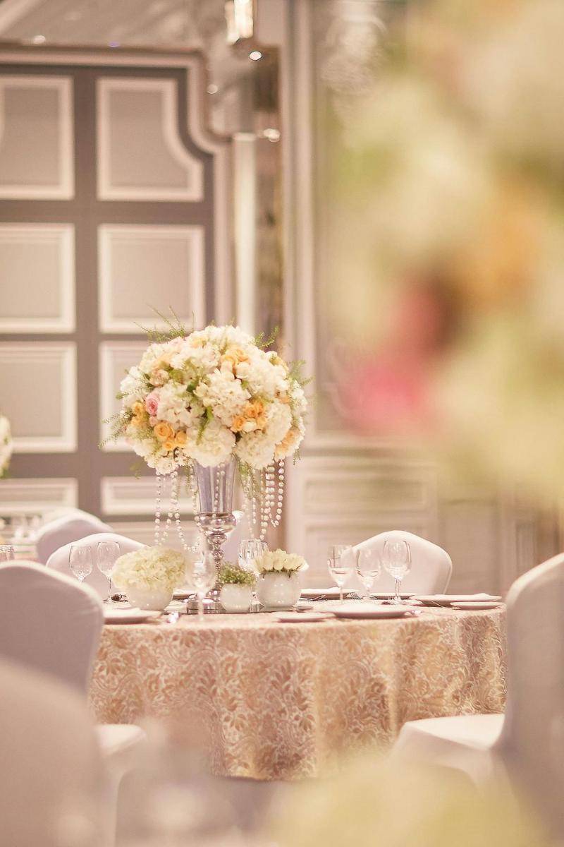 a table with a vase of flowers on it at The Ritz-Carlton, Pune in Pune