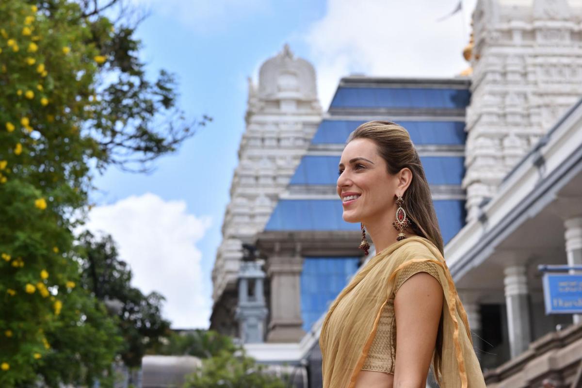 a woman standing in front of a building at Sheraton Grand Bangalore Hotel at Brigade Gateway in Bengaluru