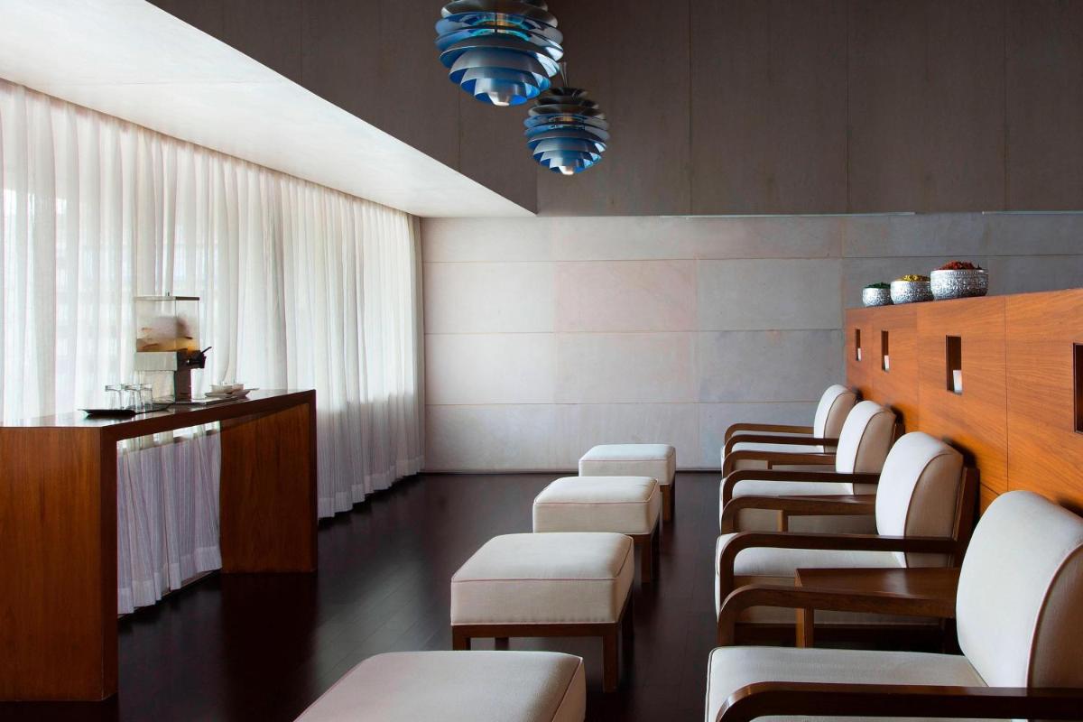 a row of chairs in a waiting room at Sheraton Grand Bangalore Hotel at Brigade Gateway in Bengaluru