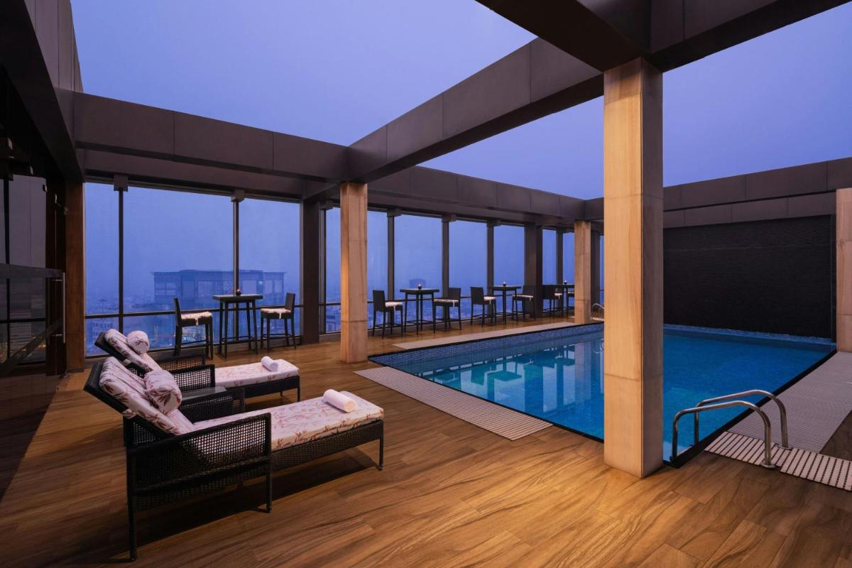a pool on the top of a building with a view at Courtyard by Marriott Amritsar in Amritsar