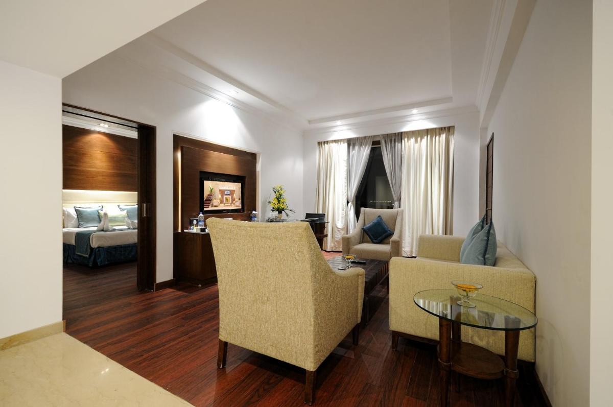 a living room with a couch and a table at Radisson Jaipur City Center in Jaipur