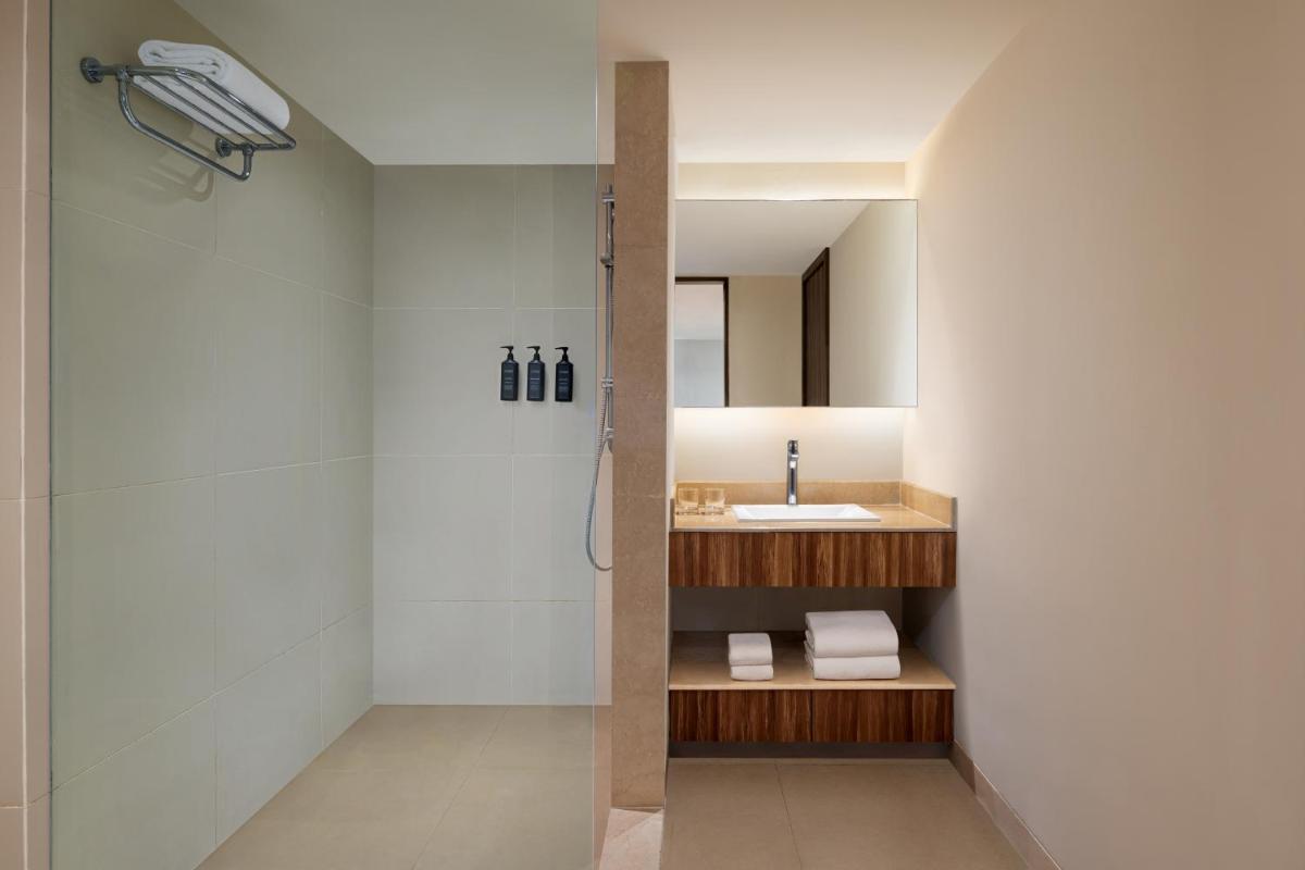 a bathroom with a sink and a shower at Sheraton Hyderabad Hotel in Hyderabad