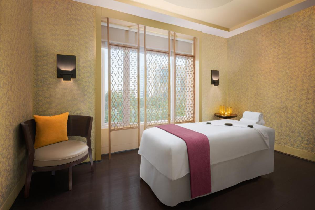 a bedroom with a large white bed and a window at Sheraton Hyderabad Hotel in Hyderabad