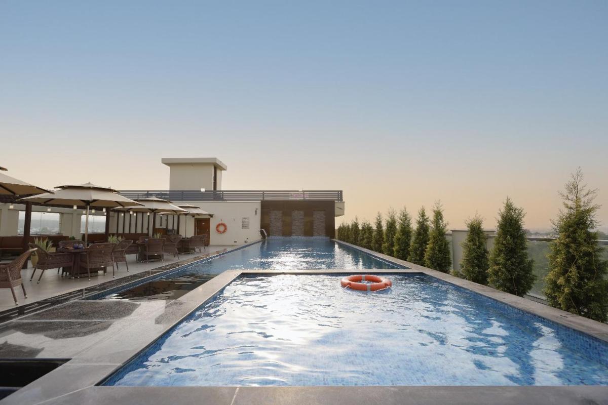 a large swimming pool on a building at Regenta Dehradun by Royal Orchid Hotels Limited in Dehradun