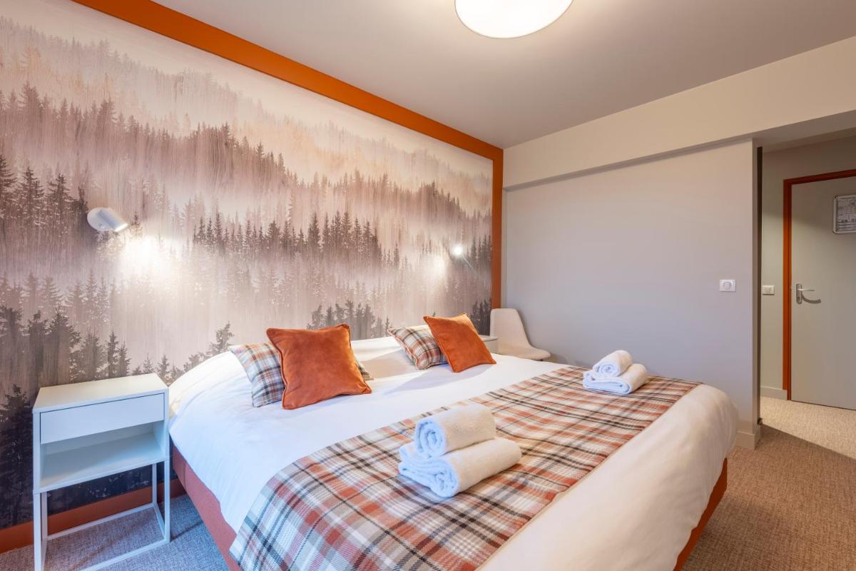 Un ou plusieurs lits dans un hébergement de l'établissement Hotel Le Bois Joli