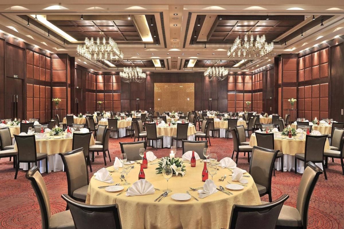 a banquet hall with tables and chairs and chandeliers at Jaipur Marriott Hotel in Jaipur +26 photos a banquet hall with tables and chairs and chandeliers at Jaipur Marriott Hotel in Jaipur +26 photos