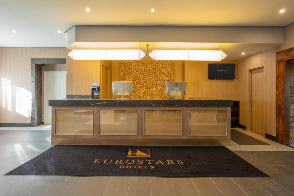 Un vestíbulo de un hotel con un mostrador de recepción en Eurostars Royal Tanau, en Baqueira Beret