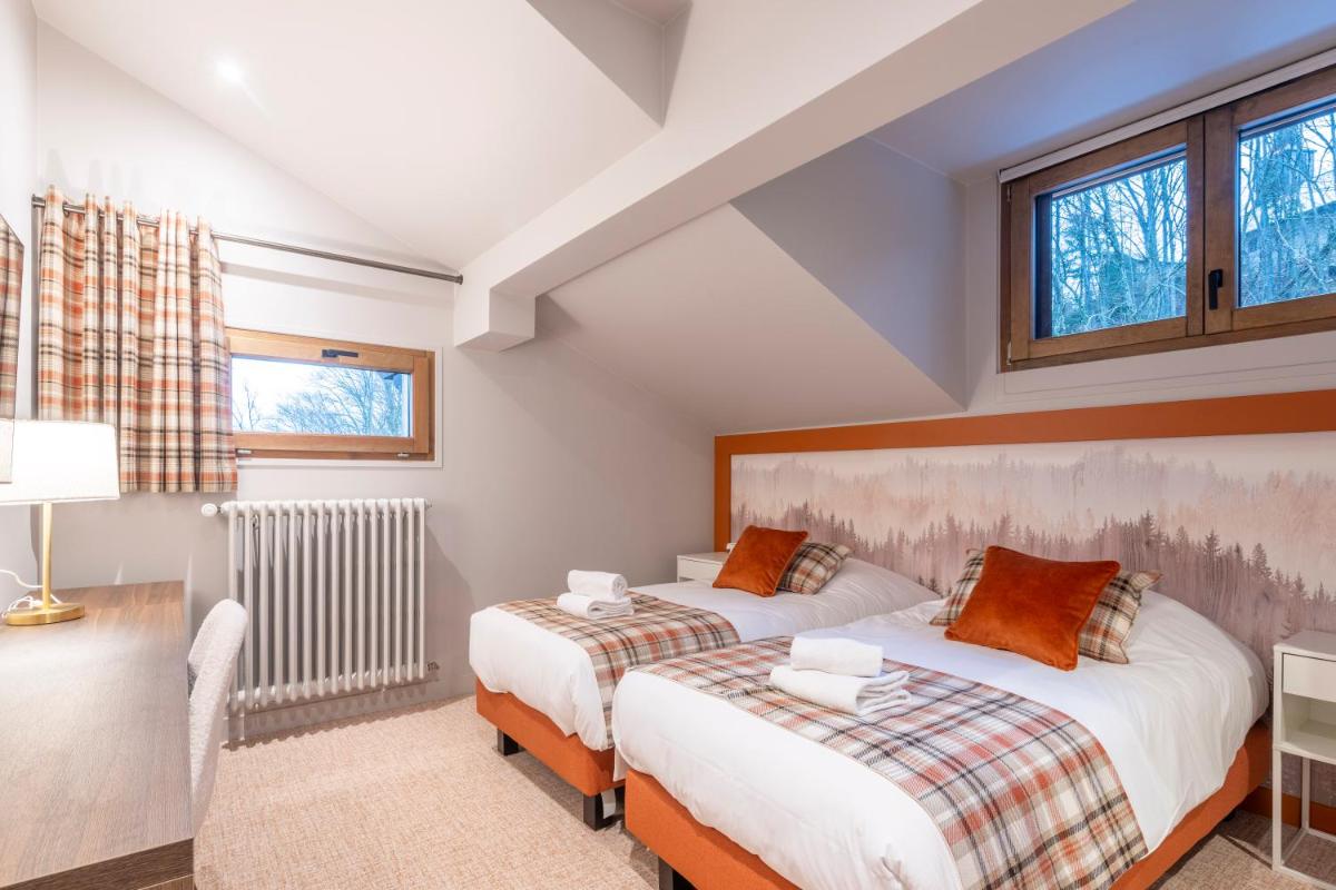 Un ou plusieurs lits dans un hébergement de l'établissement Hotel Le Bois Joli