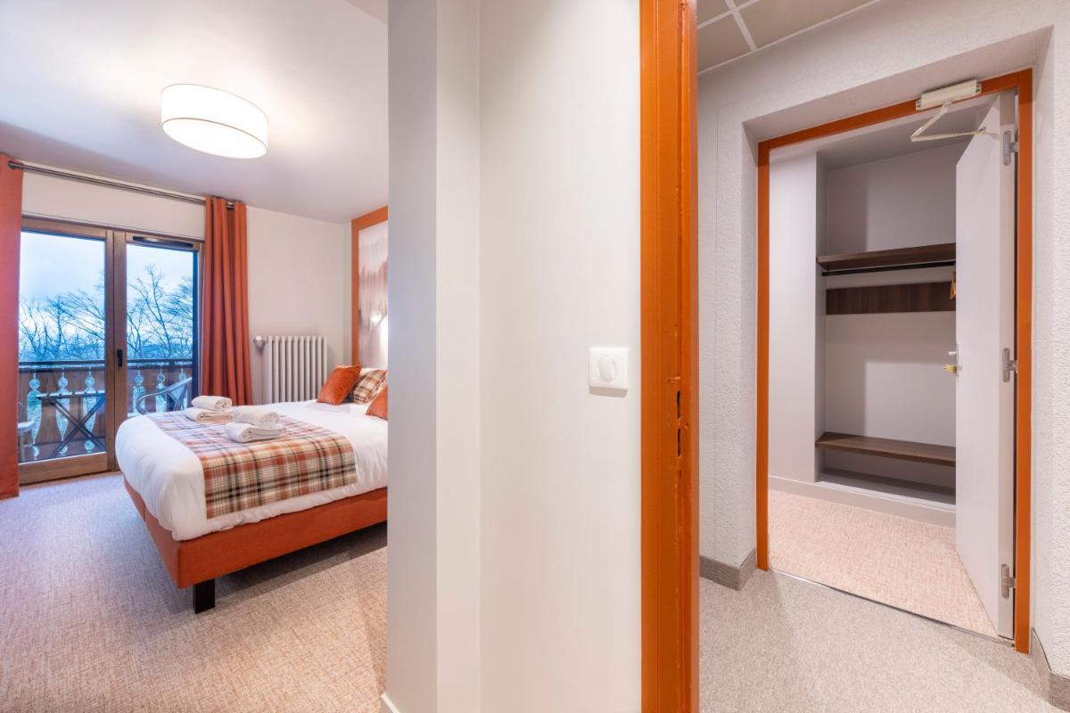 Un ou plusieurs lits dans un hébergement de l'établissement Hotel Le Bois Joli