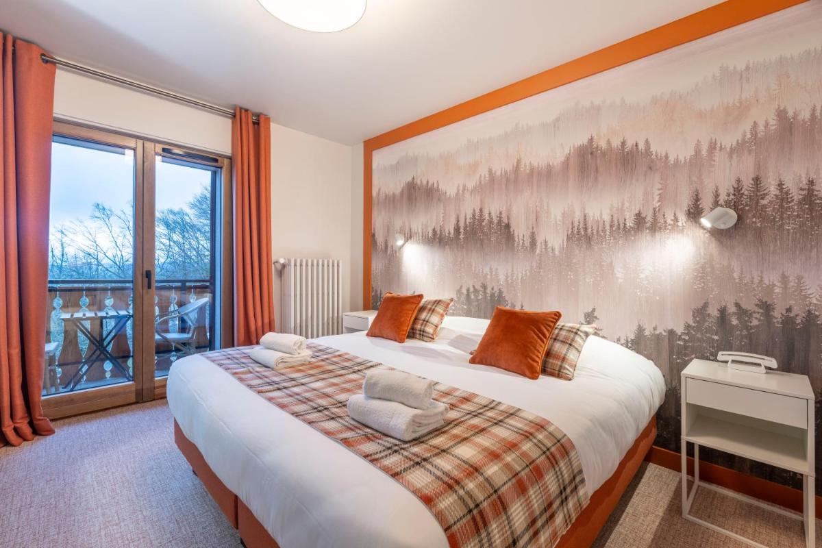 Un ou plusieurs lits dans un hébergement de l'établissement Hotel Le Bois Joli