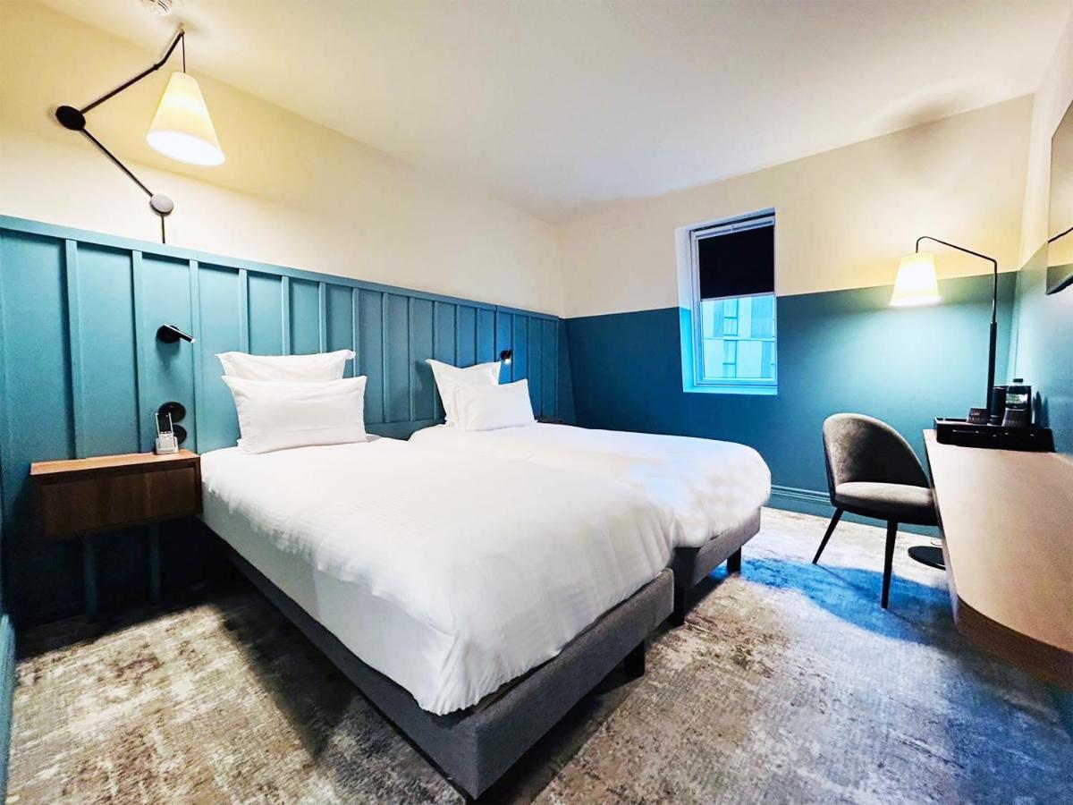 Un ou plusieurs lits dans un hébergement de l'établissement Kyriad Prestige Compiègne Hotel & Spa