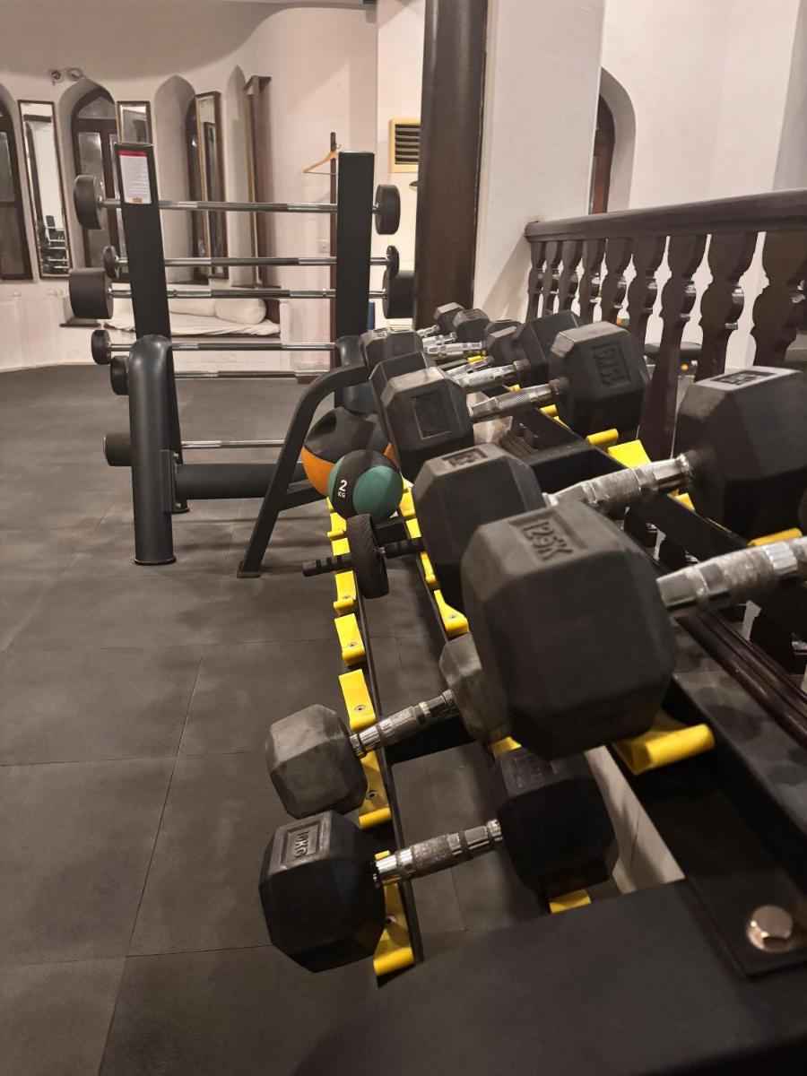 a gym with a row of dumbbells at Neemrana Fort-Palace in Neemrana