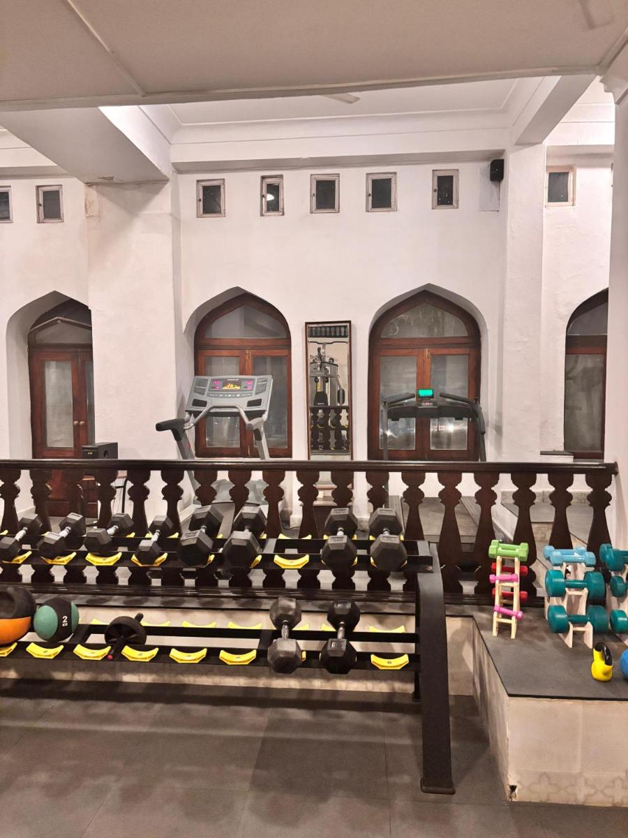a gym with dumbbells and a basketball court at Neemrana Fort-Palace in Neemrana