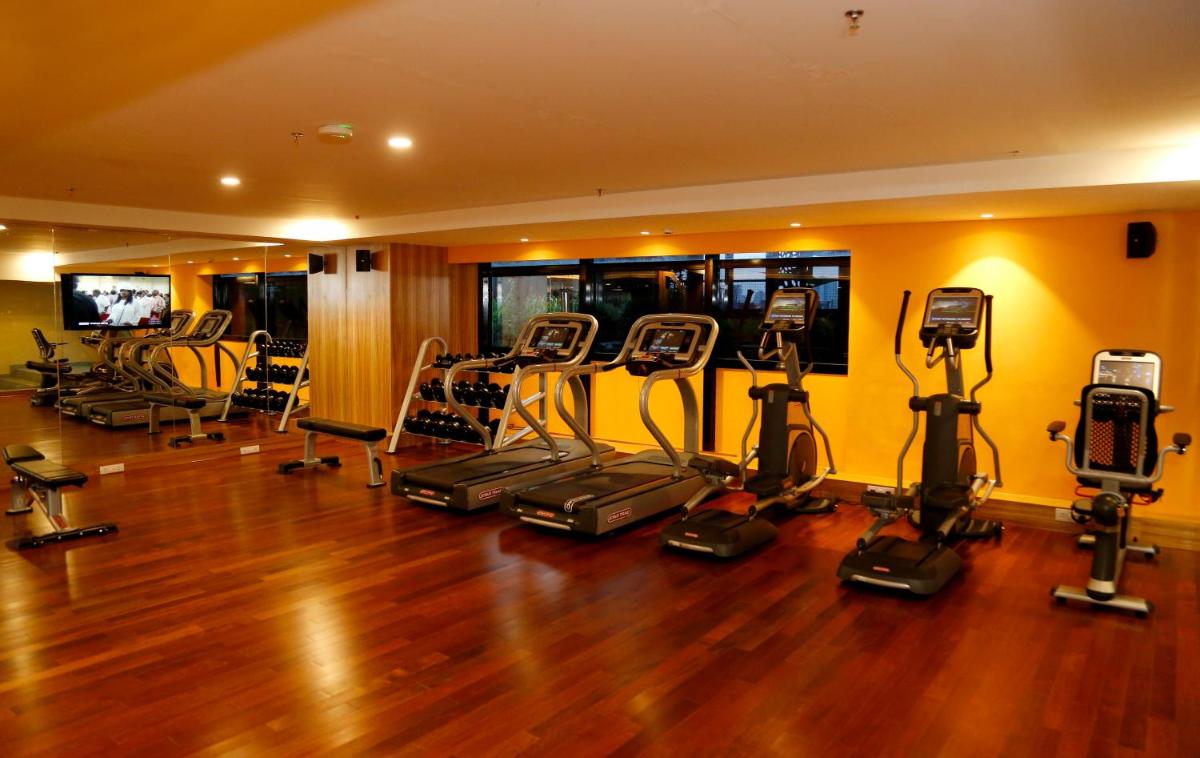a gym with a bunch of exercise bikes in a room at The Raviz Calicut in Kozhikode